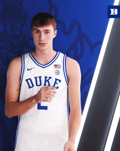 Duke Basketball Player In Front Of Blue Wall GIF