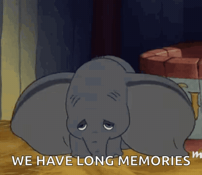 Dumbo From The Disney Movie Dumbo Is Laying Down On The Floor With His Eyes Closed . GIF
