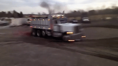 Dump Truck Driving With Smoke From Back GIF