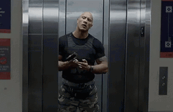 Dwayne Johnson On Elevator Loading Gun GIF