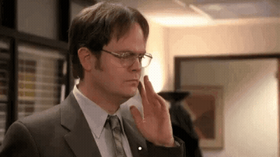 Dwight Schrute Is Wearing Glasses And A Suit And Tie . GIF
