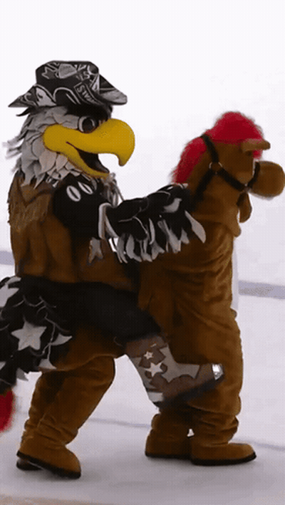Eagle Mascot Carrying Stuffed Horse With Red Mane GIF