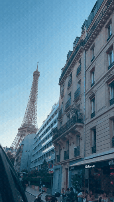 Eiffel Tower Behind Building With No Parking Sign GIF