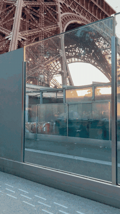 Eiffel Tower Reflected In Glass Barrier GIF