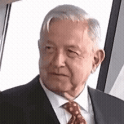 Elderly Man In Suit And Tie Looking At Camera GIF