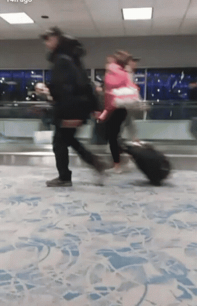 Elderly Man In Suit And Tie Walking Down Hallway GIF