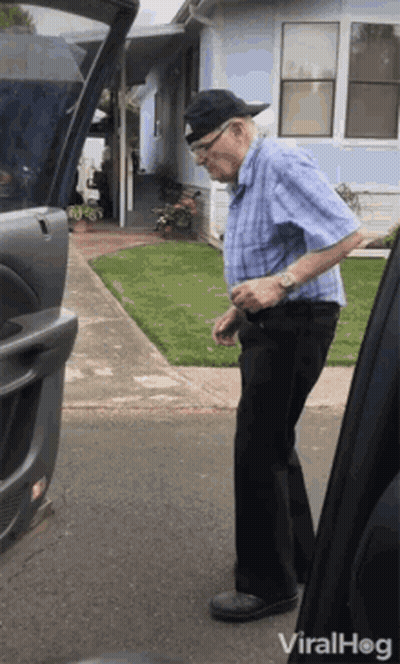 Elderly Man Standing Next To Open Car Trunk GIF