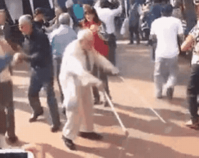 Elderly Man With Cane Dancing With Group GIF