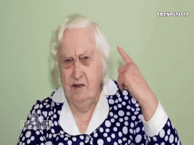Elderly Woman Blue-And-White Polka Dot Dress Covering Ear GIF