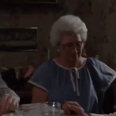 Elderly Woman Holding Framed Picture Of Two Dogs GIF