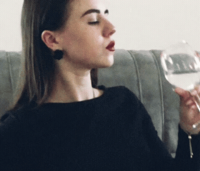 Elderly Woman Holding Puppet In Living Room GIF