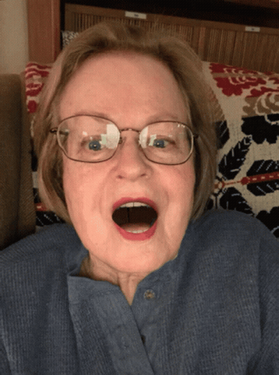 Elderly Woman In Blue Shirt And Glasses Open Mouth GIF