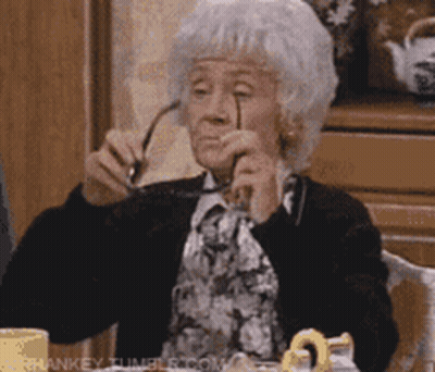 Elderly Woman In Glasses And White Hat Asking If Anyone Is Listening GIF