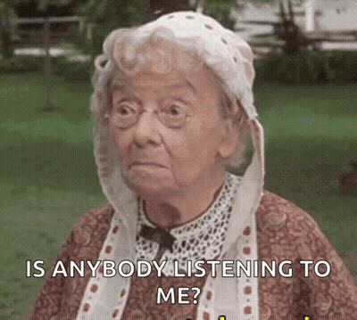 Elderly Woman In Glasses And White Hat Asking If Anyone Is Listening GIF