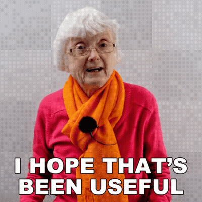 Elderly Woman In Orange Scarf And Pink Sweater Says I Hope That's Been Useful GIF