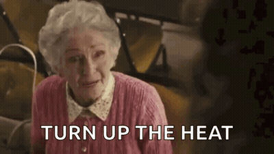 Elderly Woman in Pink Sweater Saying Turn Up The Heat