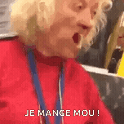 Elderly Woman in Red Sweater Making Funny Face