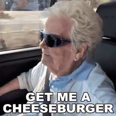 Elderly Woman In Sunglasses Driving Says Get Me A Cheeseburger GIF