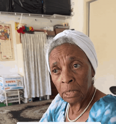 Elderly Woman In White Turban And Pearls Saying Yams GIF