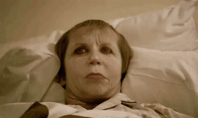 Elderly Woman Laying In Hospital Bed Making Funny Face GIF