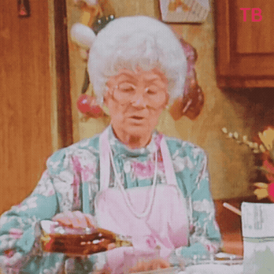 Elderly Woman Pouring Syrup Into Glass While Wearing Apron GIF