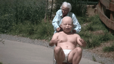 Elderly Woman Pushes Baby In Diaper GIF