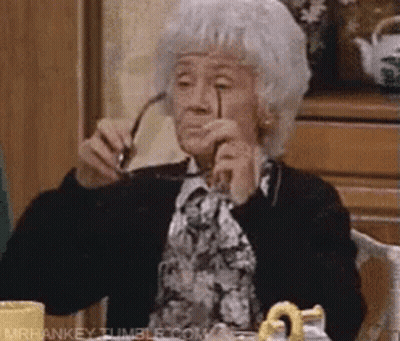 Elderly Woman Sitting Holding Glasses GIF