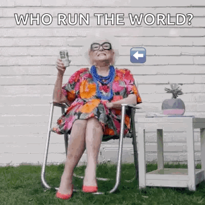 Elderly Woman Sitting Holding Remote And Phone GIF