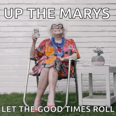 Elderly Woman Sitting In Chair Holding Beer GIF