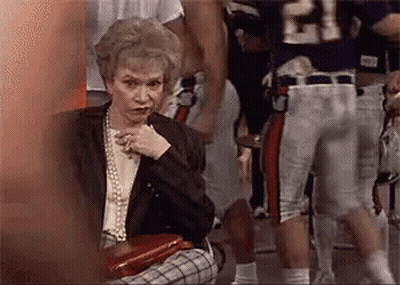 Elderly Woman Sitting In Front Of Football Player Number 21 GIF