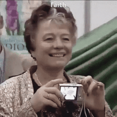 Elderly Woman Smiling Holding Camera With Faith