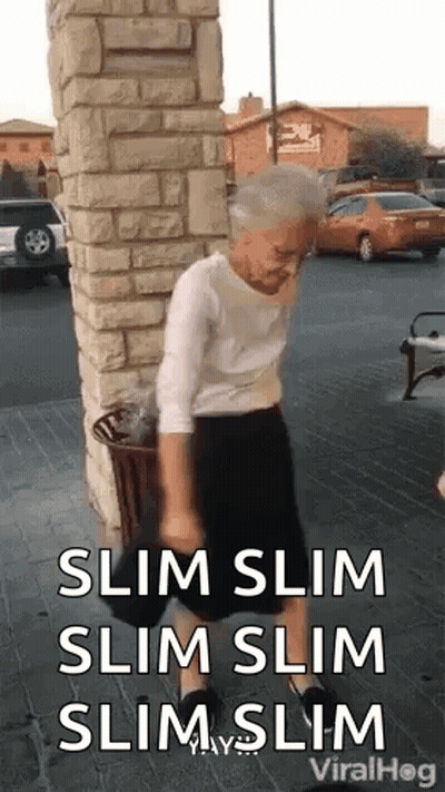 Elderly Woman Standing Next To Brick Wall GIF