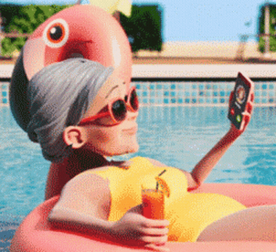 Elderly Woman Taking Selfie In Pool On Flamingo Float GIF