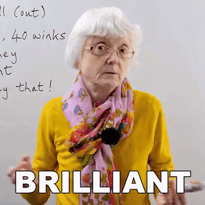 Elderly Woman With Glasses And Scarf Saying Brilliant GIF