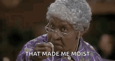 Elderly Woman With Glasses And Wig Eating Food GIF