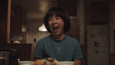 Elderly Woman With Glasses Eating Rice With Chopsticks GIF