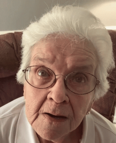 Elderly Woman With Glasses Looking At Camera GIF