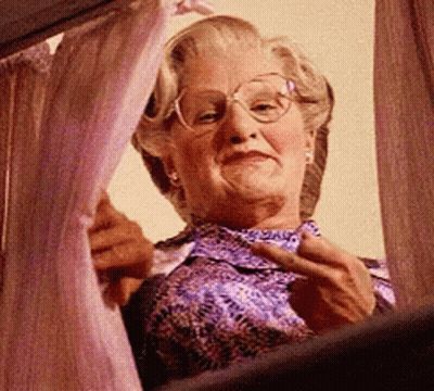 Elderly Woman With Glasses Looking Out Window GIF