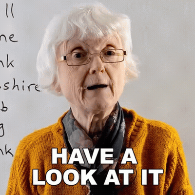 Elderly Woman With Glasses Saying Have A Look At It GIF