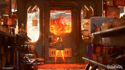 Elemental Poster Woman In Front Of Door With Fire GIF