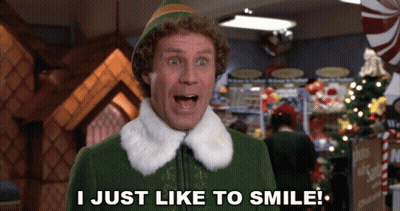 Elf Saying I Just Like To Smile Front Christmas Tree GIF