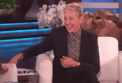 Ellen Degeneres Is Laughing While Sitting In A Chair On Ellentube GIF