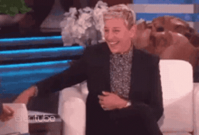 Ellen Degeneres Is Smiling While Sitting In A Chair On The Ellen Degeneres Show GIF