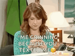 Ellie Kemper Grinning While Texting GIF