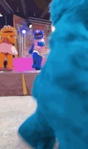 Elmo And Cookie Monster Dancing On Stage GIF
