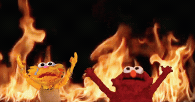 Elmo And Garlic Bread In Front Of Fire GIF