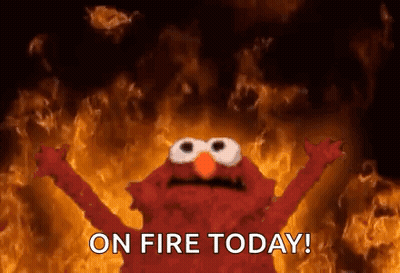 Elmo From Sesame Street In Front Of Fire Wall GIF