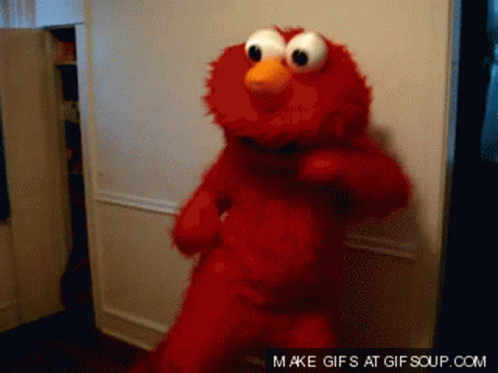Elmo From Sesame Street Is Dancing In Front Of A Door GIF