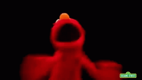 Elmo From Sesame Street Is Dancing In The Dark With A Black Background . GIF