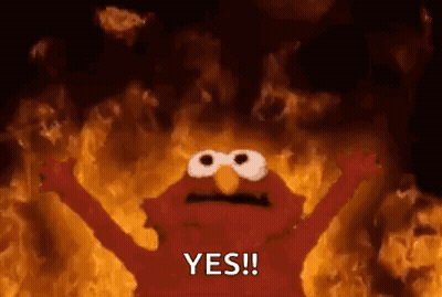 Elmo From Sesame Street Is On Fire With His Arms Outstretched And Says Yes . GIF